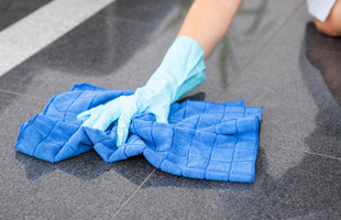 Wiping marble flooring with cloth